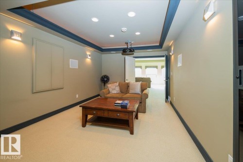Dedicated media room featuring recessed lighting, a ceiling-mounted projector, wall-mounted sconces, and an in-wall speaker system - 2413 Tegler Green, Edmonton, AB - Indoor Photo Showing Other Room