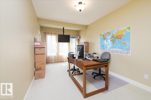 Room featuring light neutral wall paint, white trim, and light-colored carpet flooring - 2413 Tegler Green, Edmonton, AB - Indoor Photo Showing Office