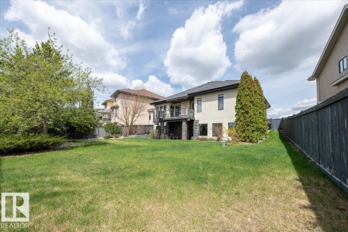 Expansive rear yard featuring a manicured lawn and mature trees - 2413 Tegler Green, Edmonton, AB - Outdoor