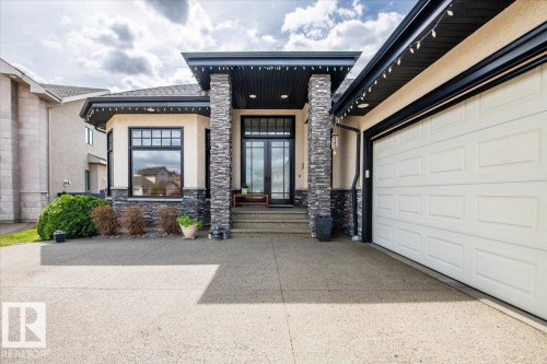 Contemporary exterior with a stucco finish and stone veneer accents - 2413 Tegler Green, Edmonton, AB - Outdoor