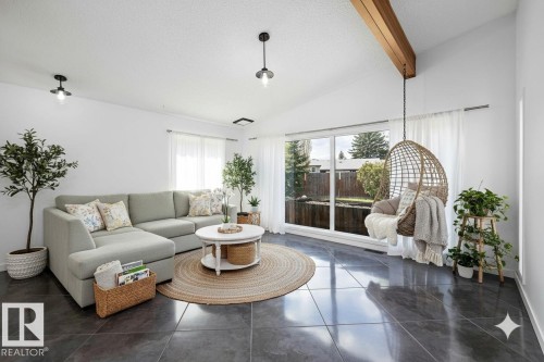 Vaulted ceiling with exposed wood beam and white walls - 11525 37A Avenue Nw, Edmonton, AB - Indoor Photo Showing Living Room