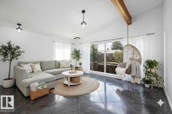 Vaulted ceiling with exposed wood beam and white walls - 