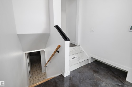 Stairwell featuring contrasting dark tile flooring and white walls - 11525 37A Avenue Nw, Edmonton, AB - Indoor Photo Showing Other Room