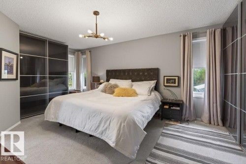 Primary bedroom features space for a king size bed, walk-in closet along with 2 wardrobe cabinets - 49 52257 Rge Road 231, Rural Strathcona County, AB 