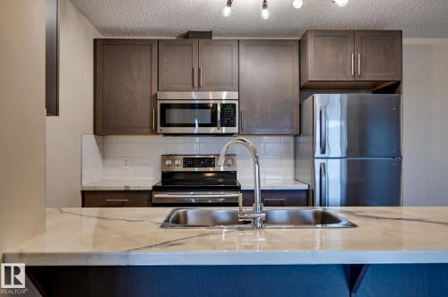 408 6084 Stanton Drive, Edmonton, AB - Indoor Photo Showing Kitchen With Stainless Steel Kitchen With Double Sink With Upgraded Kitchen