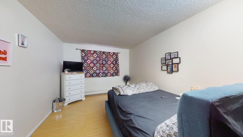 Room featuring light wood-finish flooring and neutral wall tones - 402 2624 Millwoods East Road E, Edmonton, AB - Indoor Photo Showing Bedroom