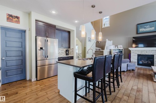 173 Sheppard Circle, Leduc, AB - Indoor Photo Showing Kitchen With Fireplace