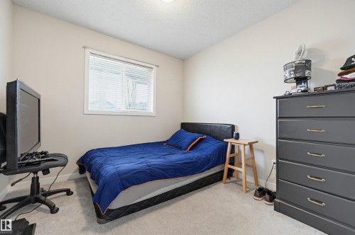 Neutral wall color with a single window featuring horizontal blinds - 11 3380 28A Avenue Nw, Edmonton, AB - Indoor Photo Showing Other Room