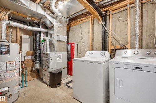 Utility area featuring a water heater, furnace system, exposed ductwork, and unfinished concrete walls - 11 3380 28A Avenue Nw, Edmonton, AB - Outdoor With Deck Patio Veranda With Exterior