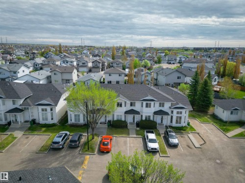 Multi-unit property featuring white siding and dark shingle roofing - 11 3380 28A Avenue Nw, Edmonton, AB - Outdoor With View