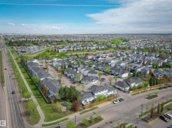 Aerial perspective showcasing a residential community with a mix of detached homes and townhome-style residences - 