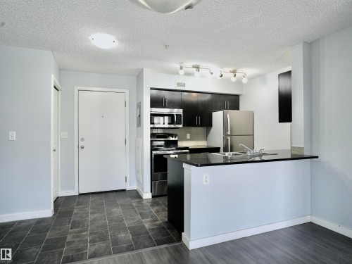 320 5816 Mullen Place, Edmonton, AB - Indoor Photo Showing Kitchen With Double Sink