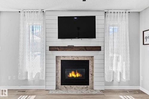 3205 41A Avenue, Edmonton, AB - Indoor Photo Showing Living Room With Fireplace