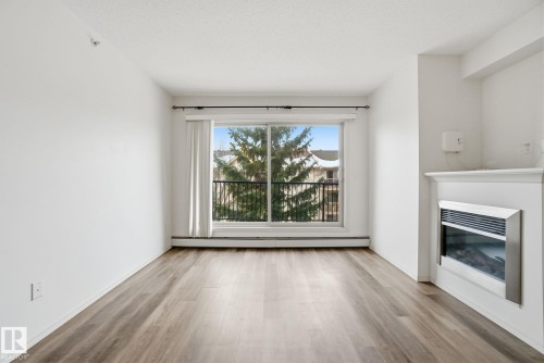 424 17011 67 Avenue, Edmonton, AB - Indoor Photo Showing Living Room With Fireplace