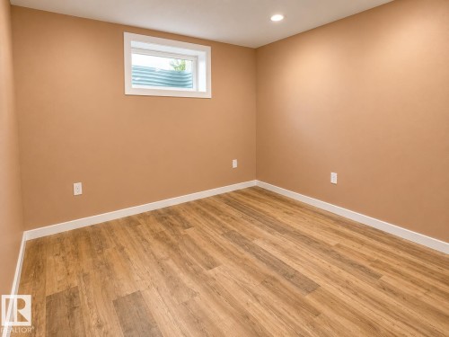 Spacious room with wood-finish flooring, recessed ceiling lighting, and a drop ceiling - 4418 45 Avenue, Bonnyville Town, AB 