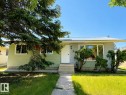 Light green exterior with a metal roof and a concrete pathway - 4418 45 Avenue, Bonnyville Town, AB 