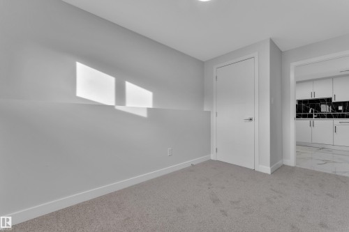 Carpeted room with light grey walls and white trim - 5118 17A Avenue Nw, Edmonton, AB - Indoor Photo Showing Other Room