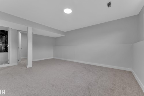 Spacious room with new carpeting, light gray walls, white trim, and recessed ceiling lighting - 5118 17A Avenue Nw, Edmonton, AB - Indoor Photo Showing Other Room