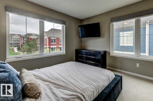 Spacious room featuring neutral painted walls, light-toned carpet flooring, and white trim - 67 603 Watt Boulevard, Edmonton, AB - Indoor Photo Showing Bedroom