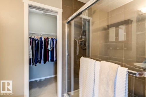 Walk-in closet with wire shelving and carpet flooring - 67 603 Watt Boulevard, Edmonton, AB - Indoor Photo Showing Bathroom