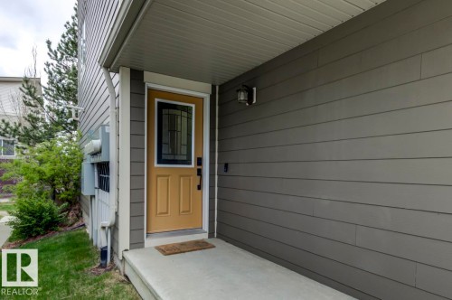 Entryway with a light tan door featuring a decorative glass insert - 67 603 Watt Boulevard, Edmonton, AB - Outdoor With Exterior