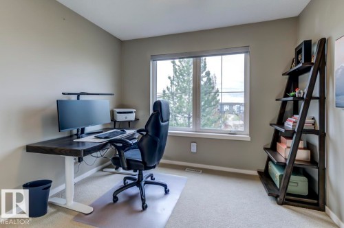 Bright room with a large window, neutral wall paint, and beige carpet flooring - 67 603 Watt Boulevard, Edmonton, AB - Indoor Photo Showing Office