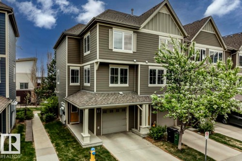 Multi-level townhome featuring a neutral exterior siding, white trim accents, and a covered entry - 67 603 Watt Boulevard, Edmonton, AB - Outdoor