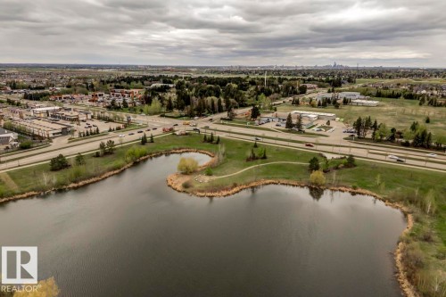 Expansive pond with natural green surroundings, bordering an arterial road - 67 603 Watt Boulevard, Edmonton, AB - Outdoor With Body Of Water With View
