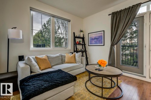 Hardwood-style flooring throughout - 67 603 Watt Boulevard, Edmonton, AB - Indoor Photo Showing Living Room