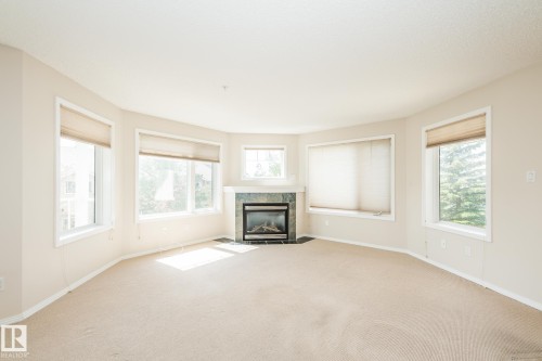 210 2420 108 Street, Edmonton, AB - Indoor Photo Showing Living Room With Fireplace