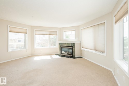 210 2420 108 Street, Edmonton, AB - Indoor Photo Showing Living Room With Fireplace