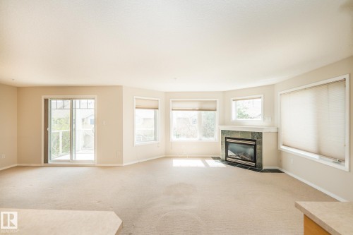 210 2420 108 Street, Edmonton, AB - Indoor Photo Showing Living Room With Fireplace