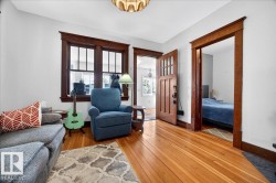 Warm wood-finish flooring complemented by substantial wood trim around windows and doorways - 