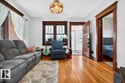 Warm wood-finish flooring complements dark wood trim and window frames - 
