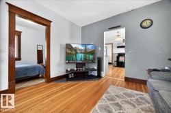 Hardwood flooring extending throughout, complemented by light gray wall finishes - 