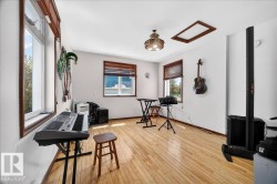 Bright room featuring wood-finish flooring and white painted walls - 