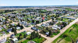 Aerial perspective of a residential neighborhood with a mix of single-story homes and established trees - 