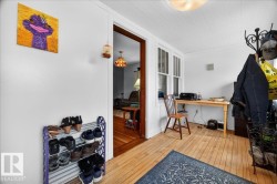 Bright interior space featuring wood-finish flooring, white walls, and a white beadboard ceiling - 
