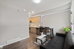 Open concept living area with wood-finish flooring - 