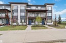 Contemporary multi-level exterior with a mix of white siding, dark paneling, and stone accents - 456 Allard Boulevard, Edmonton, AB  - Outdoor With Facade 