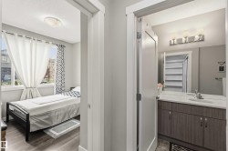 Contemporary bathroom vanity featuring a quartz countertop, integrated sink, and dual-door storage cabinetry - 