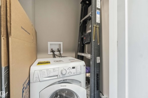 Laundry area with a front-loading washing machine, water hookups, and neutral wall tones - 456 Allard Boulevard, Edmonton, AB - Indoor Photo Showing Laundry Room