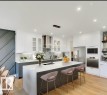 Modern kitchen featuring a large central island with seating, integrated sink, and pendant lighting - 13011 186 Avenue, Edmonton, AB  - Indoor Photo Showing Kitchen With Upgraded Kitchen 