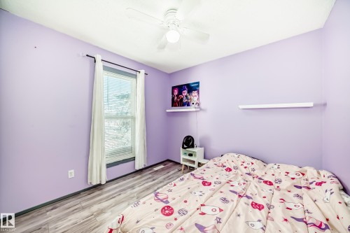 Room with wood-finish flooring and a white ceiling fan - 214A Warwick Road, Edmonton, AB - Indoor Photo Showing Bedroom