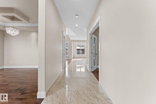 Spacious entry hallway featuring large format tile flooring and recessed lighting - 16543 132 Street, Edmonton, AB - Indoor Photo Showing Other Room