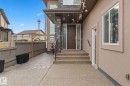 Stone facade entry with a dark wood door, flanked by a full-length frosted glass panel - 16543 132 Street, Edmonton, AB  - Outdoor With Exterior 