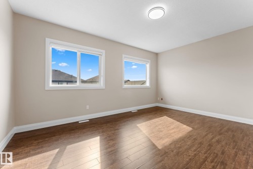 Room featuring wood-finish flooring, neutral wall paint, and white trim - 16543 132 Street, Edmonton, AB - Indoor Photo Showing Other Room