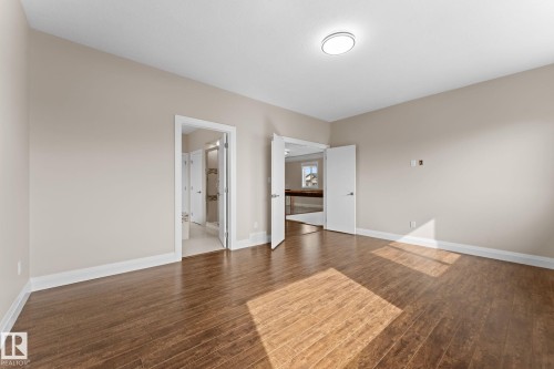 Spacious interior room featuring wood-finish flooring and neutral wall tones - 16543 132 Street, Edmonton, AB - Indoor Photo Showing Other Room