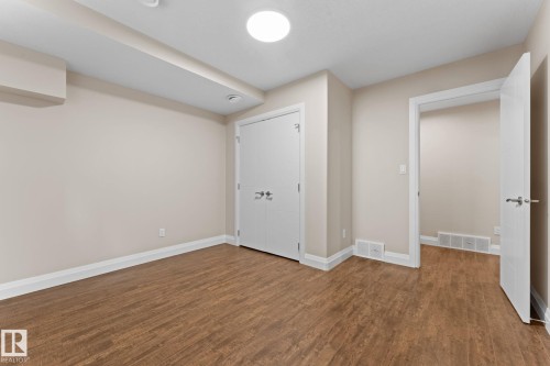 Room featuring wood-finish flooring, light-toned walls, and white trim - 16543 132 Street, Edmonton, AB - Indoor Photo Showing Other Room