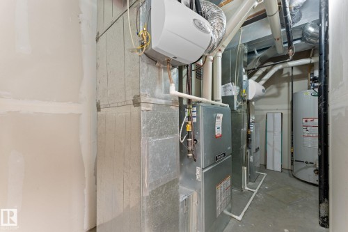 Mechanical room featuring a water heater, furnace, and extensive ductwork - 16543 132 Street, Edmonton, AB - Indoor Photo Showing Basement
